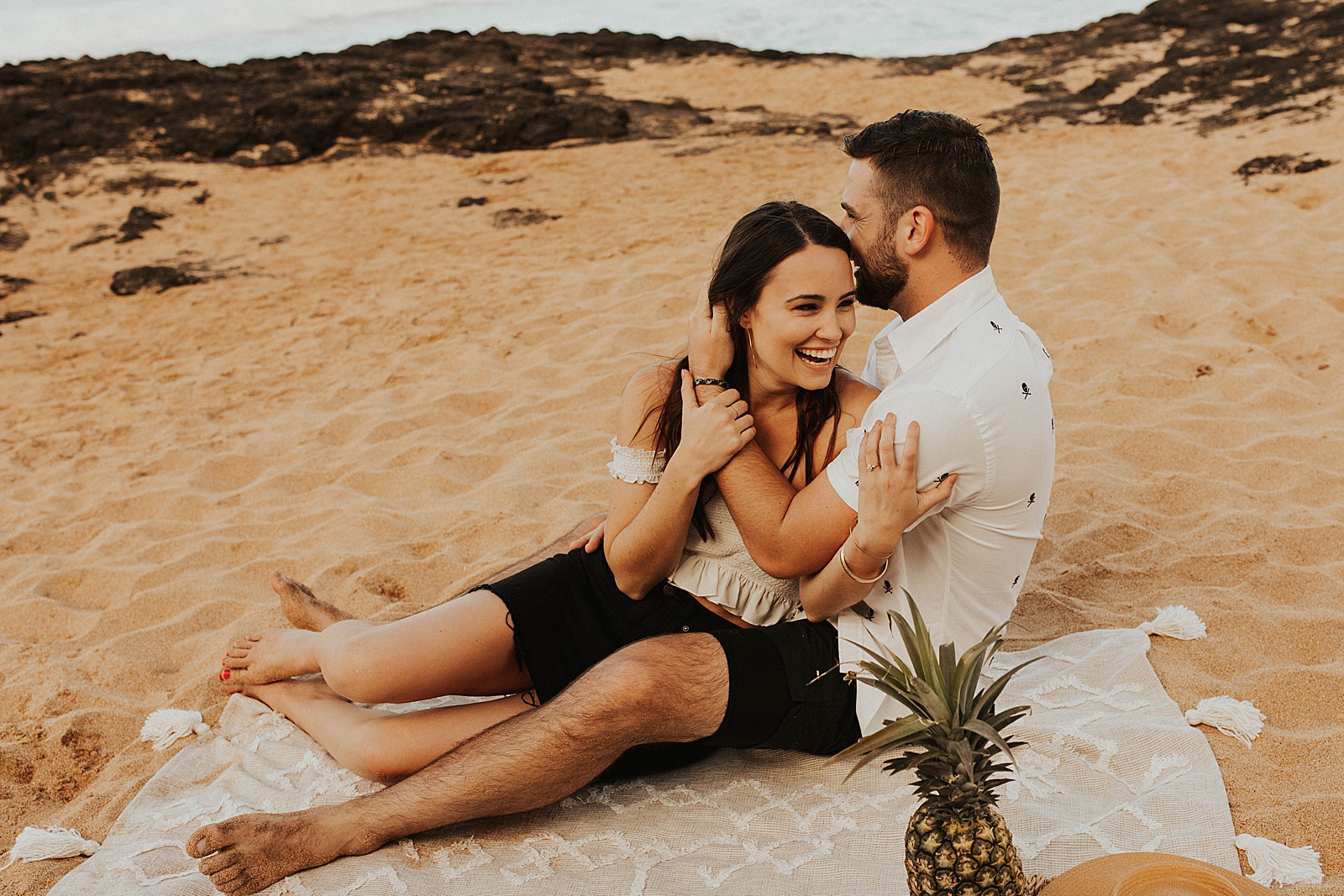 Fun and playful engagement photos at Secret Beach in Kauai, Hawaii. 