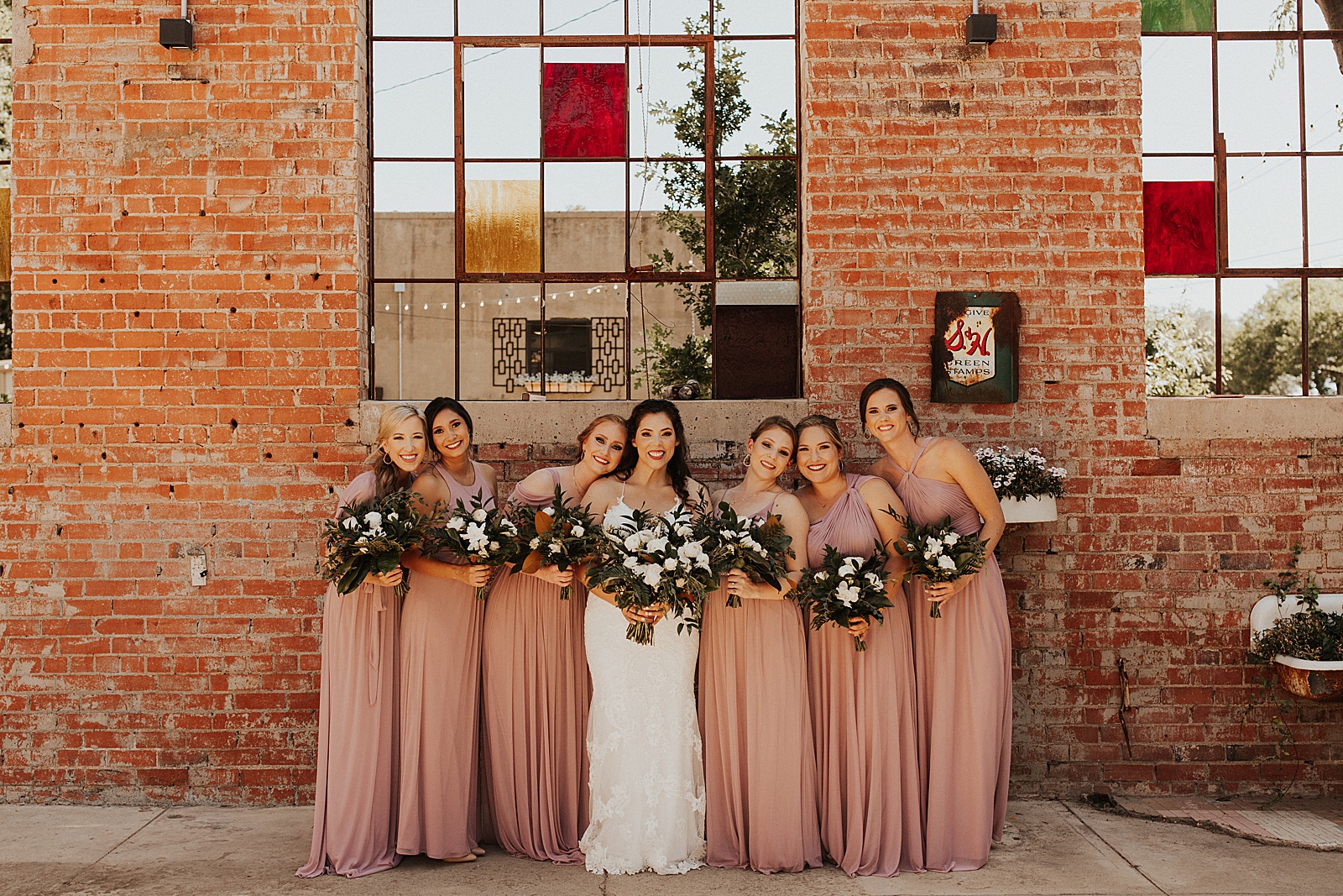A bridal party wedding photo at the Soda District Courtyard in Abilene.