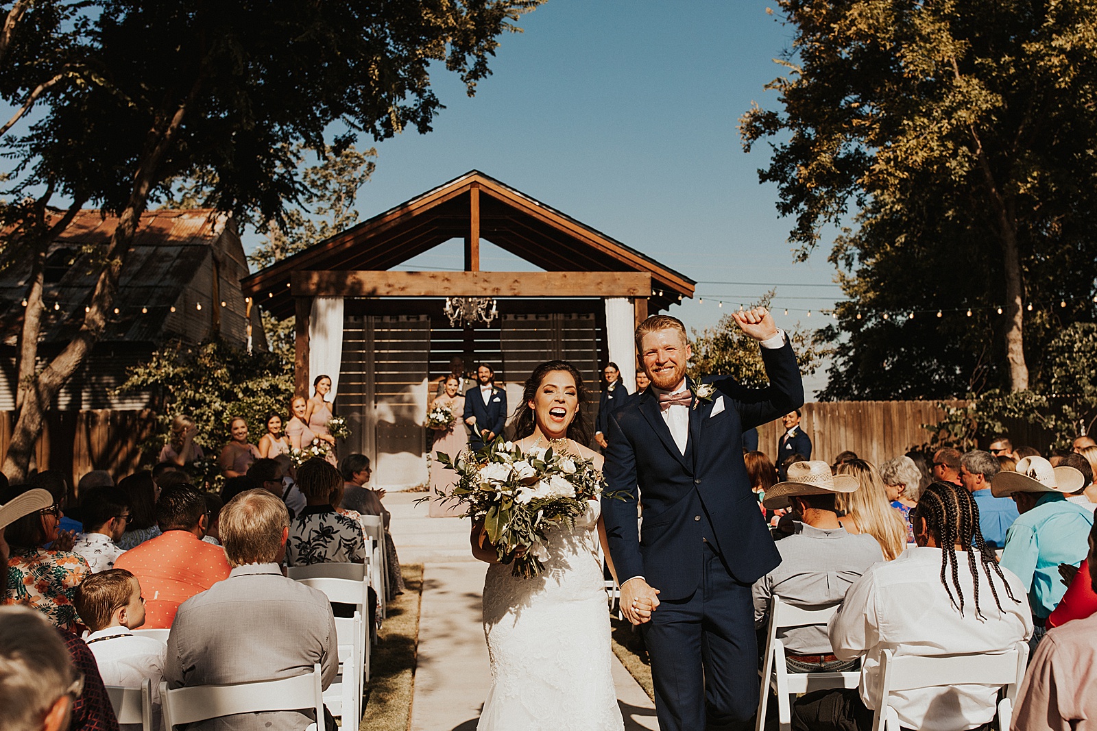 An outdoor ceremony wedding photo at the Soda District Courtyard in Abilene.