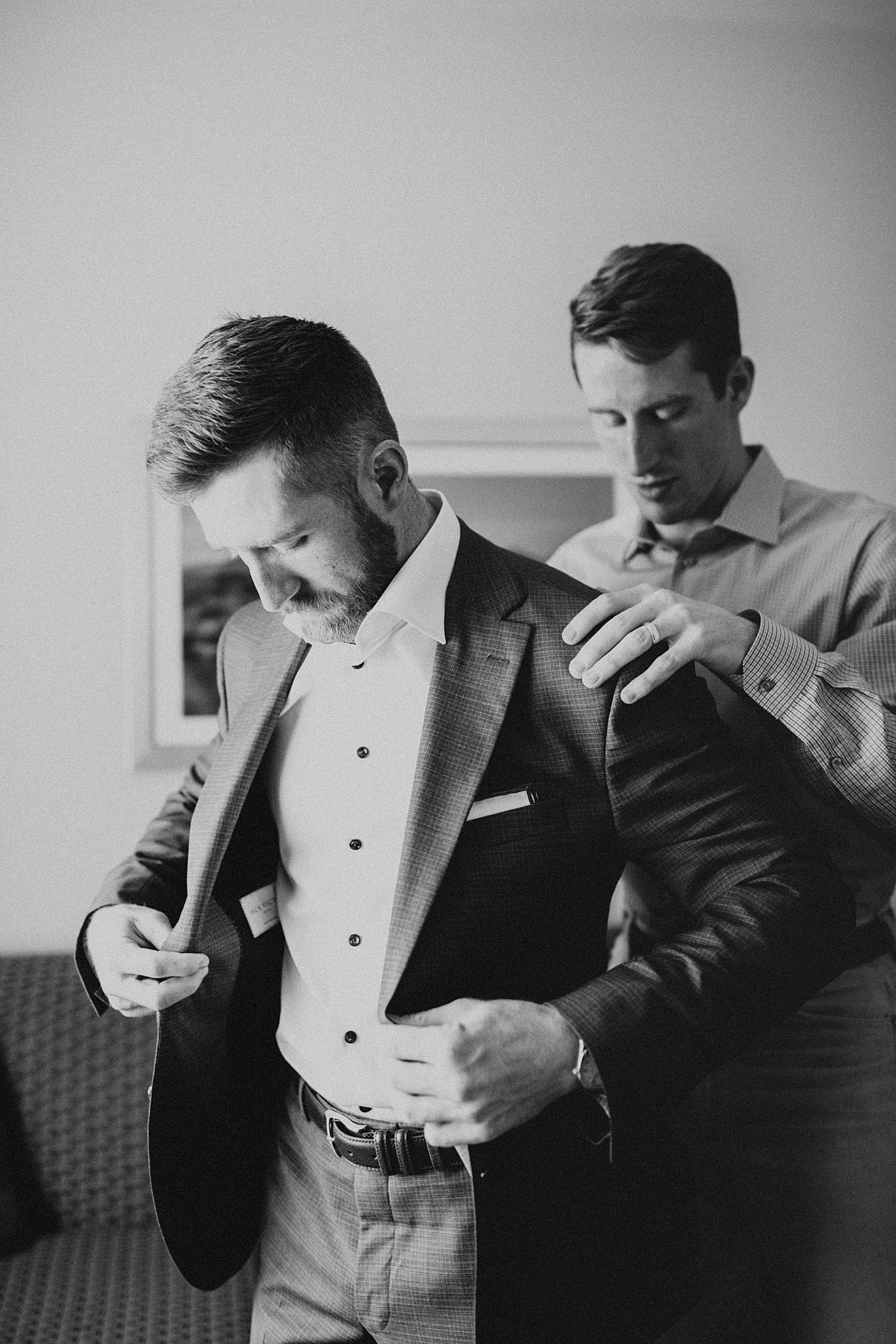 Groom getting ready at this boho Arches National Park wedding.